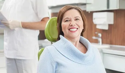Smiling older woman in dental chair