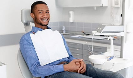 A young, male patient waiting to see the dentist for a regular checkup