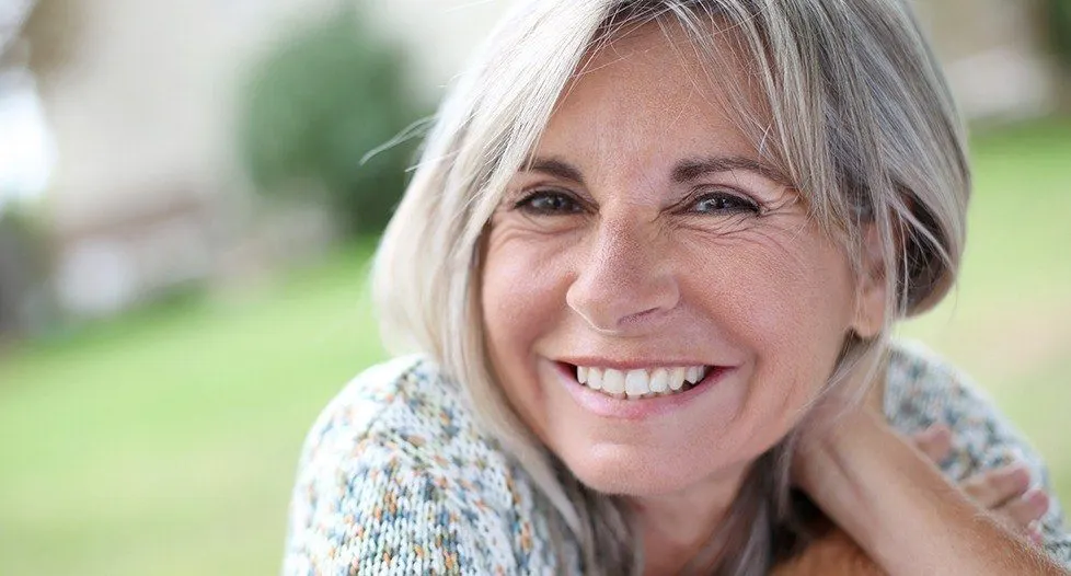 Older woman smiling outdoors
