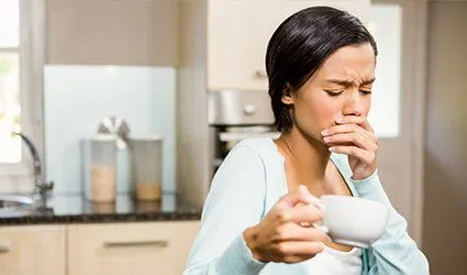 Woman covering her mouth