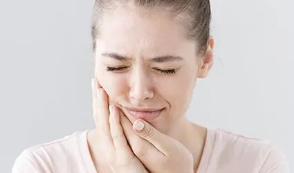 Woman holding jaw in place