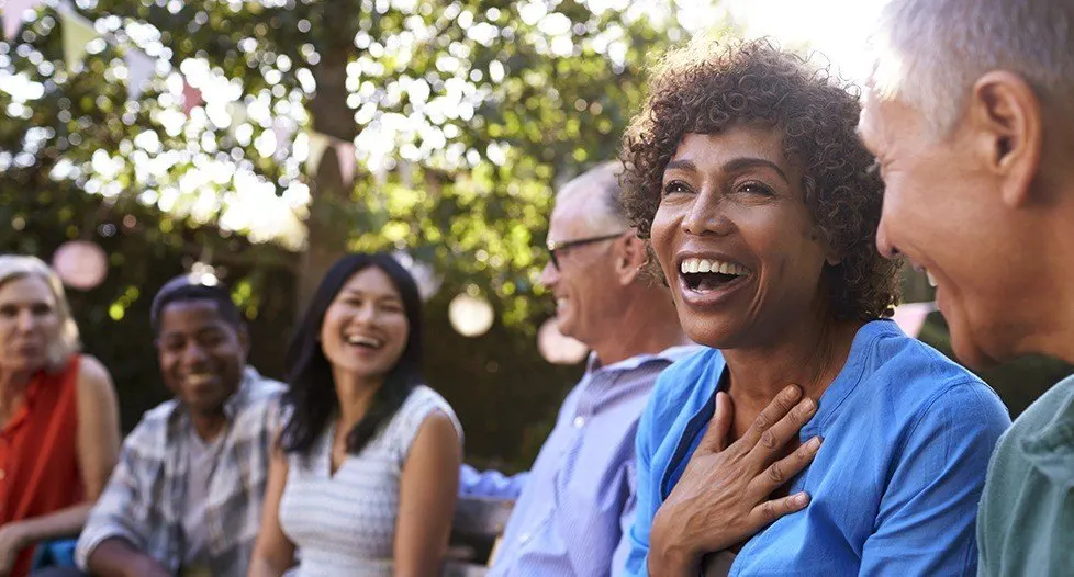 Group of friends laughing together outdoors