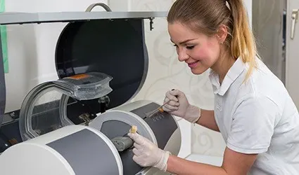 Dental team member using CEREC milling unit