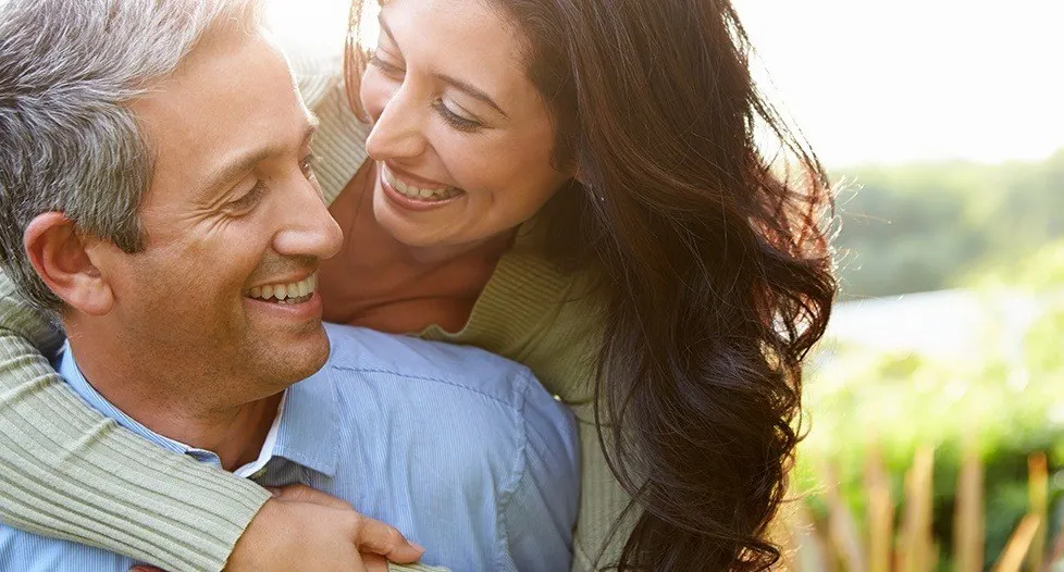 Smiling man and woman outdoors