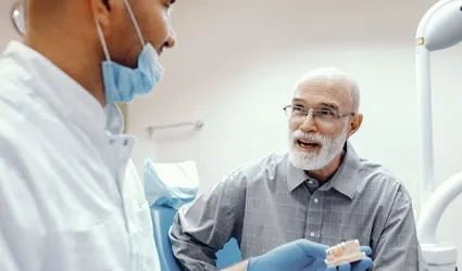 man asking his dentist about the cost of dentures in Park City