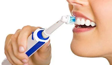 Closeup of patient brushing teeth