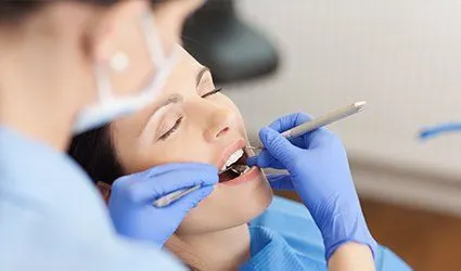Woman with eyes closed in the dental chair
