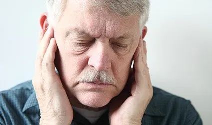 Man in pain holding jaw