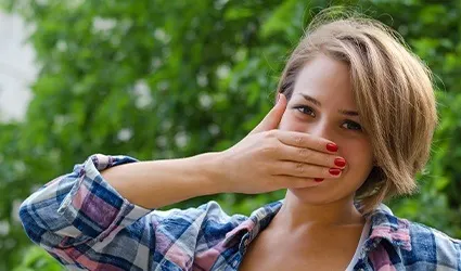 Woman covering her mouth