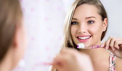 Woman brushing teeth