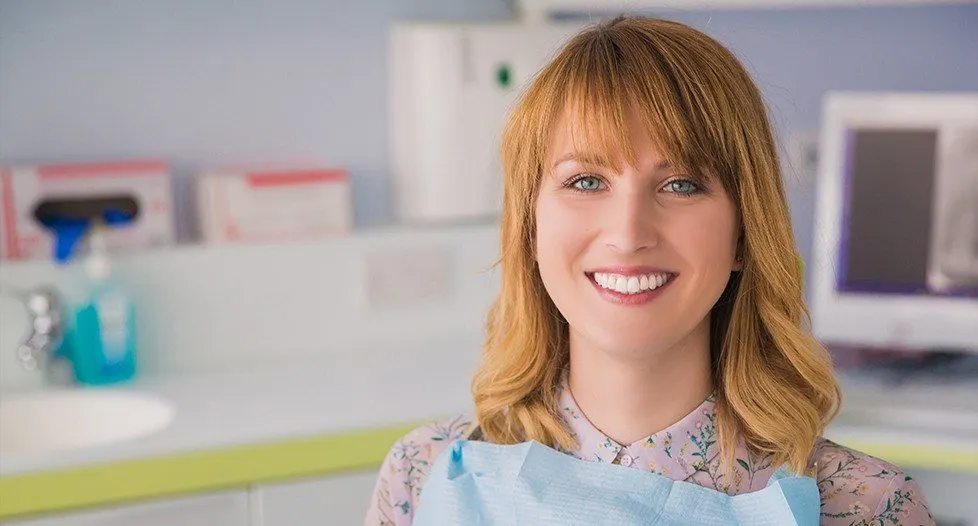 Woman in dental chair smiling