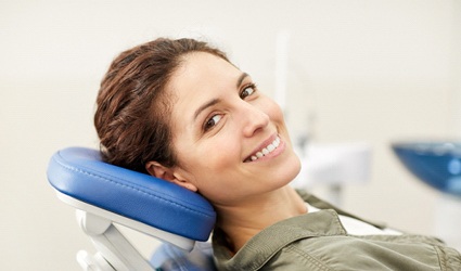Woman smiling in dental chair looking at camera