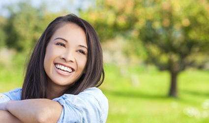 Woman smiling outside with beautiful, white teeth