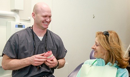a cosmetic patient admiring her new teeth at Park City Dentistry